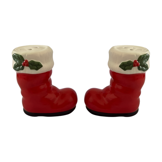 Red ceramic Santa boot salt and pepper shakers with white trim and holly leaf accents