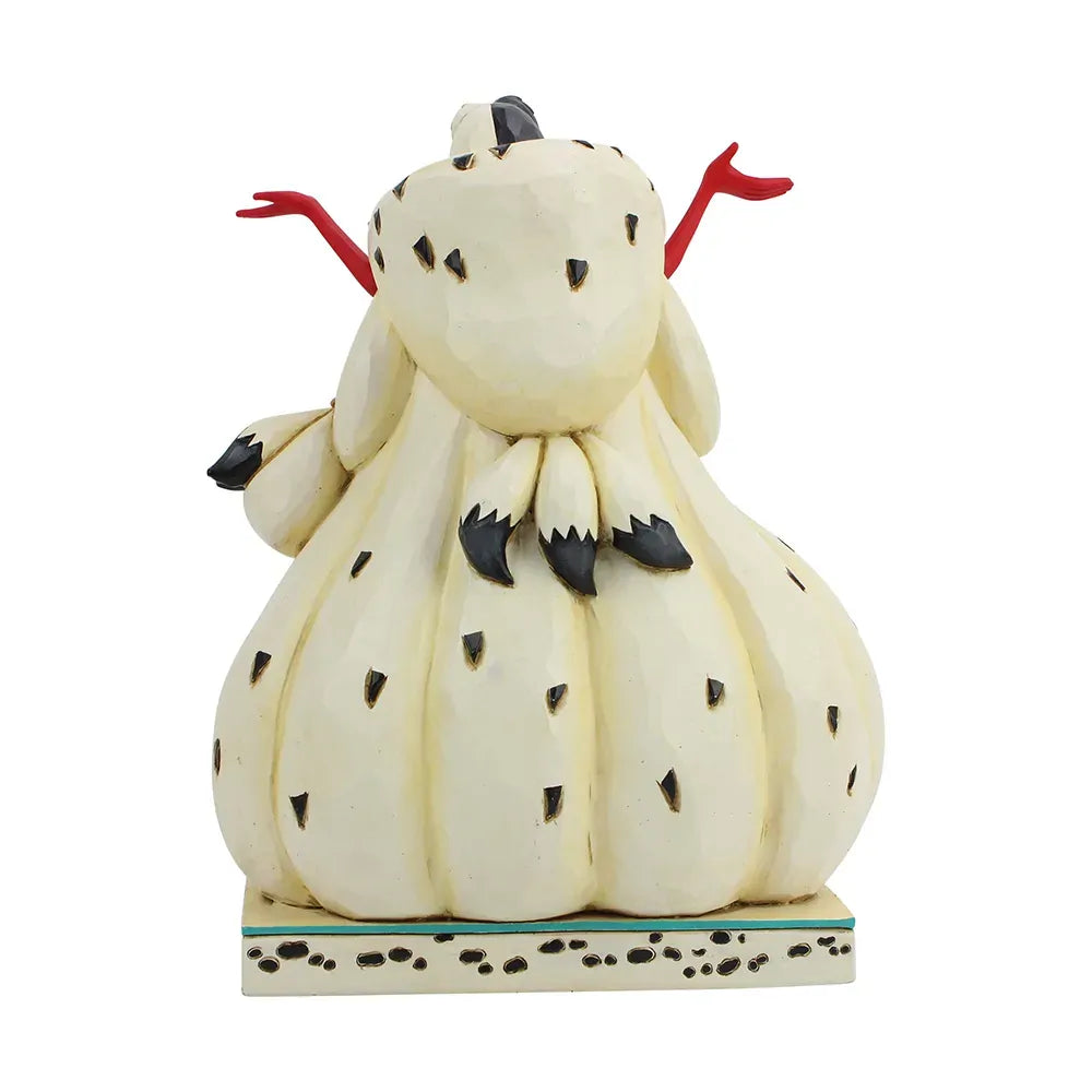 Cruella De Vil figurine side view showing spotted coat volume and a Dalmatian puppy at the base on a spot patterned base