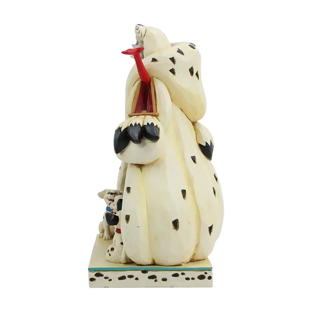 Cruella De Vil figurine opposite side view showing large spotted coat with two Dalmatian puppies at base, red detail visible