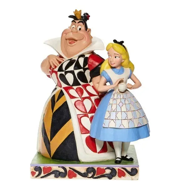 Alice and Queen of Hearts figurine, Queen in heart-patterned gown beside Alice in blue dress, on heart base