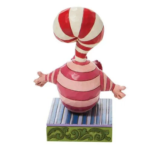 Rear view of Cheshire Cat Christmas figurine with a candy cane tail curling overhead, arms outstretched on a striped base