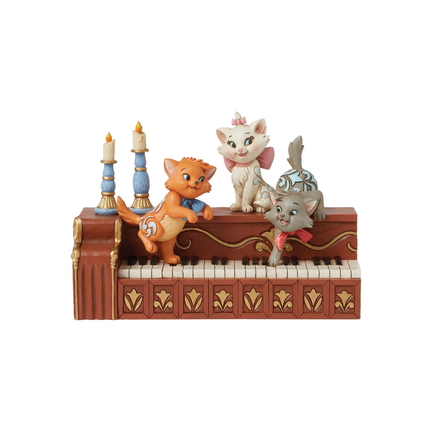 Marie, Toulouse and Berlioz figurine from The Aristocats on a piano with blue candlesticks, gold scrollwork detail