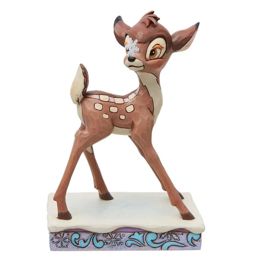 Front-facing view of a Bambi fawn figurine with a snowflake detail on his face, standing on a decorative winter base