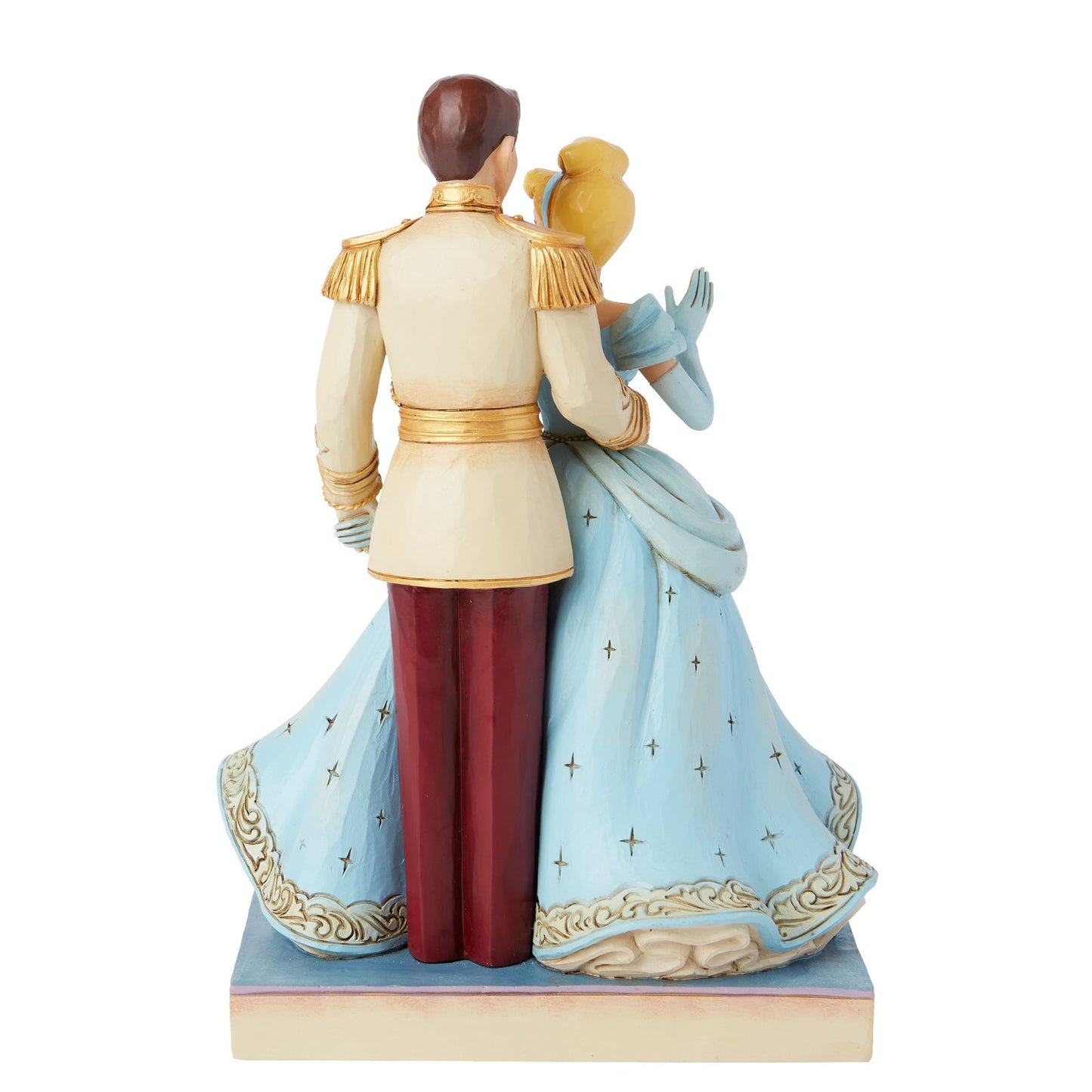 Rear view of Cinderella and Prince Charming figurine, blue star-detailed gown, cream and gold uniform, scrollwork base