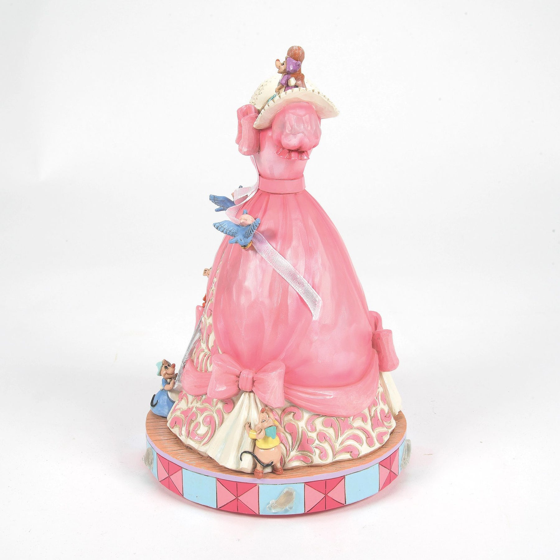 Side view of Cinderella pink ball gown mannequin figurine with mice and bluebirds adding ribbon, scrollwork skirt detail