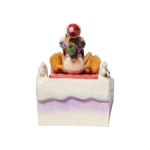 Rear view of Donald Duck and Pluto Christmas sleigh figurine, white and purple folk art scrollwork base visible