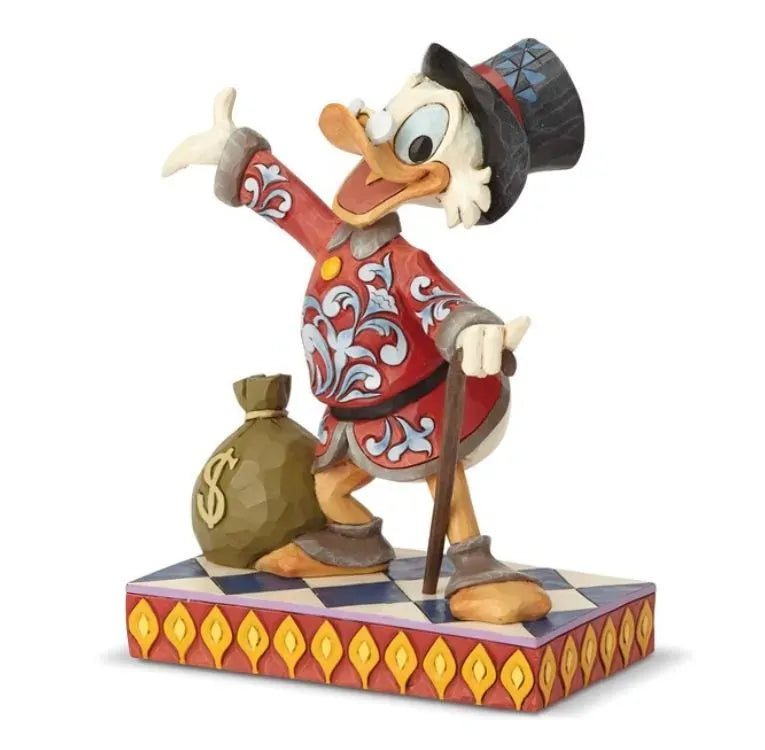 Scrooge McDuck figurine front view, red scrollwork coat, cane, money bag with dollar sign, on a red and gold geometric base