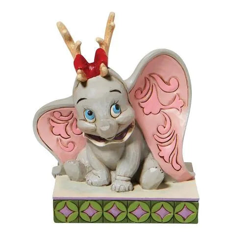 Front view of Dumbo Christmas figurine with reindeer antlers and red bow, big ears fanned open, scrollwork detail inside