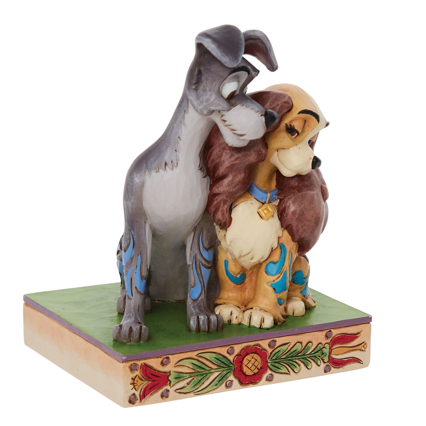 Side view of Lady and the Tramp figurine, Tramp leaning over Lady, showing scroll coat detail on a floral painted base
