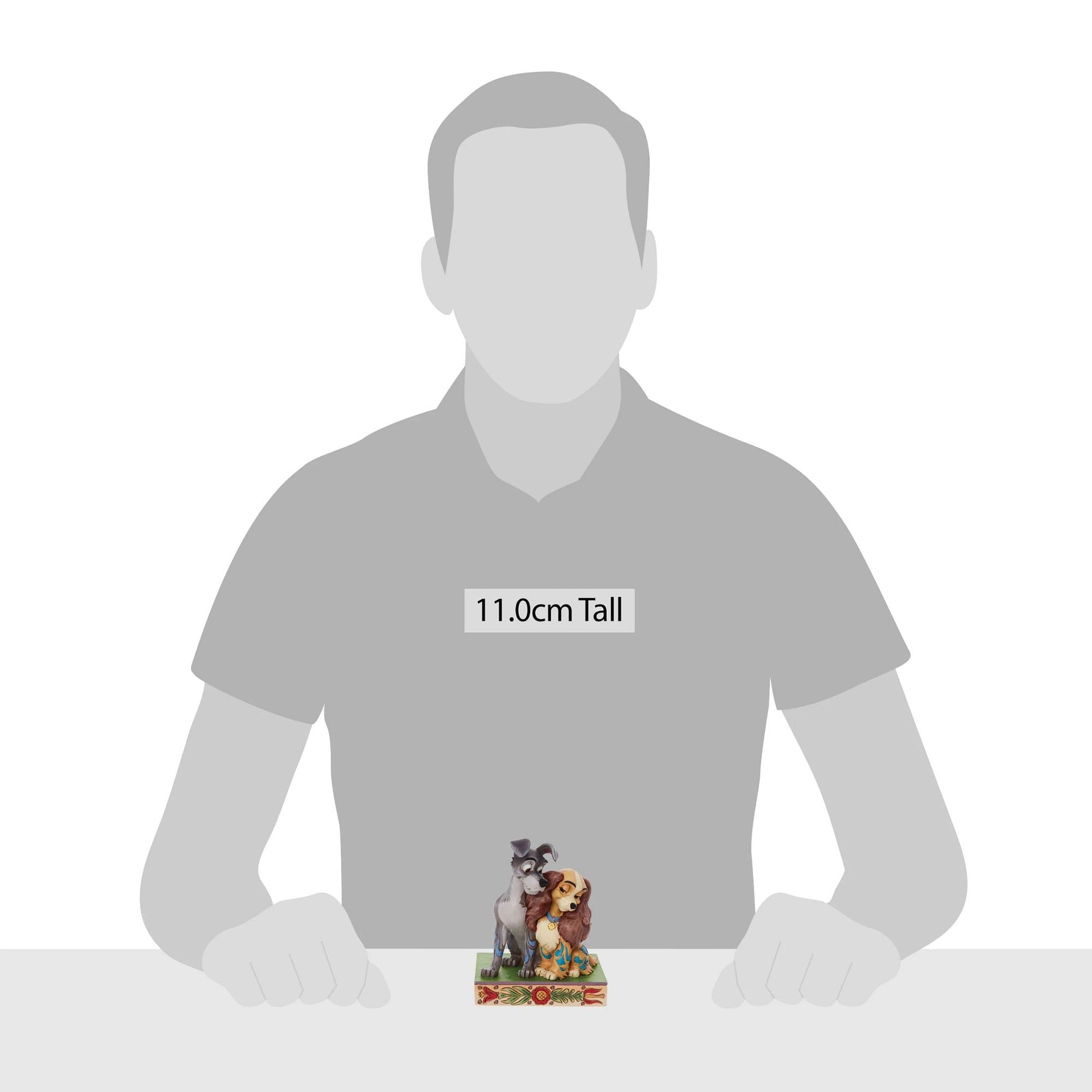 Lady and the Tramp figurine shown against human silhouette for scale, measuring 11.0cm tall 