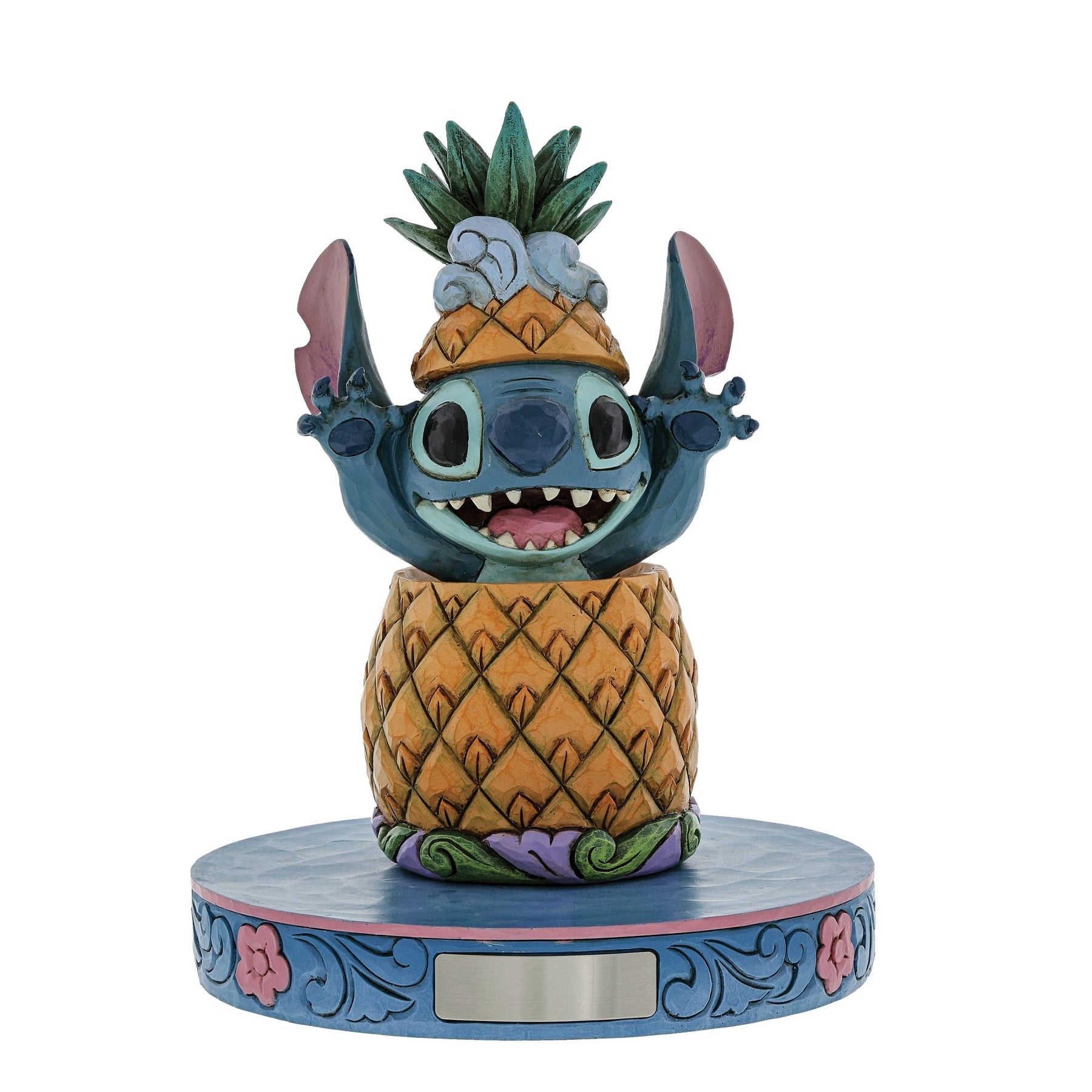 Close-up of Stitch figurine emerging from a pineapple with pineapple crown, wide grin and ears spread, on wave base