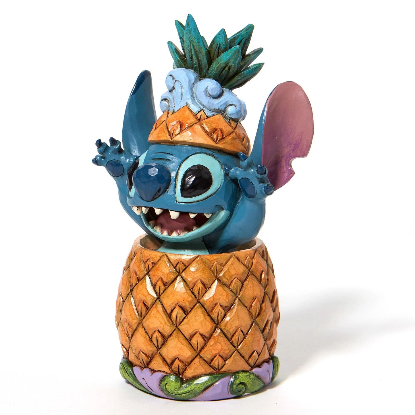 Stitch figurine popping out of a pineapple, wearing a pineapple crown, grinning with arms raised on a wave-scroll base