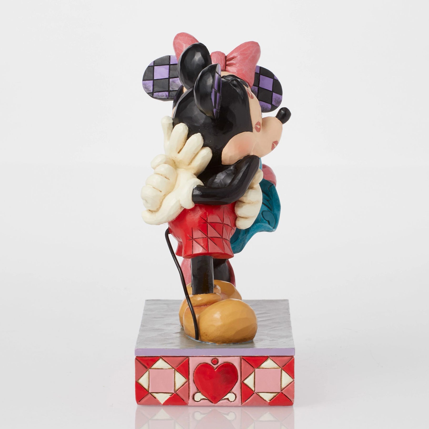 Side view of Minnie Mouse kissing Mickey Mouse figurine, teal dress detail, heart-patterned painted base