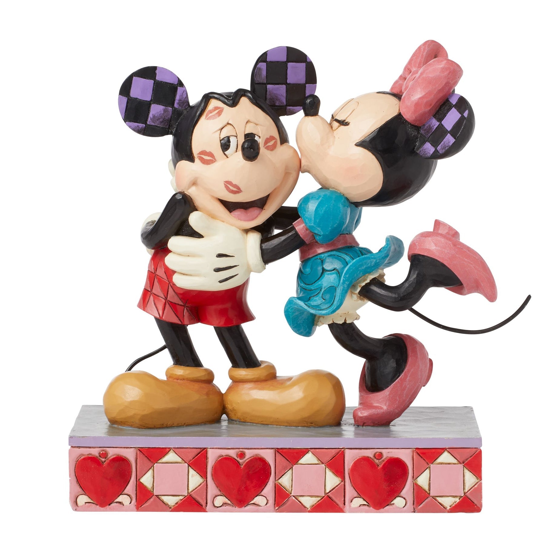 Mickey and Minnie Mouse figurine embracing with kiss marks on Mickey's face, heart-patterned painted base 