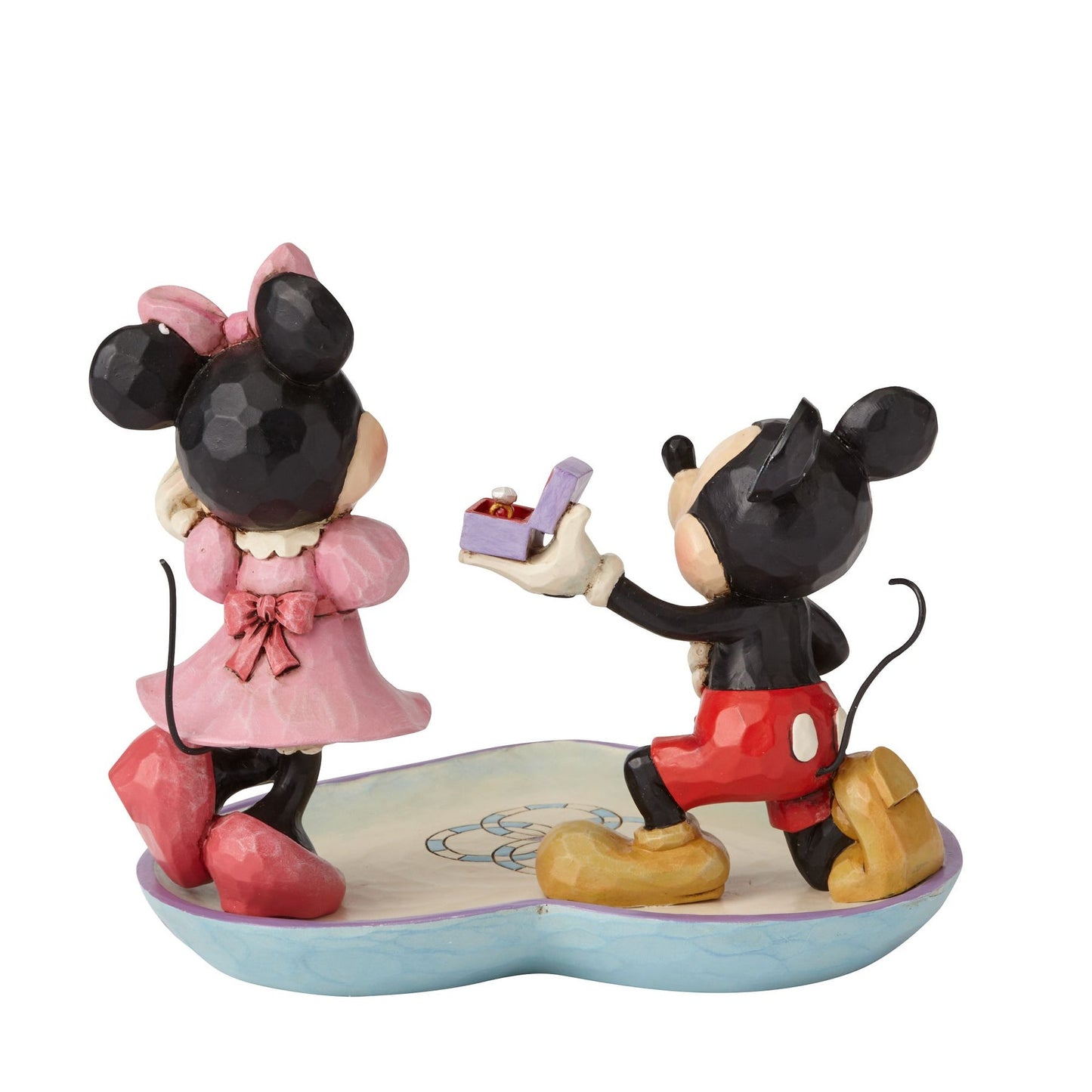 Mickey and Minnie proposal figurine rear view, Mickey kneeling with ring box extended toward Minnie on a heart-shaped base