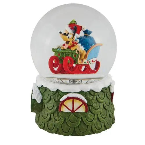 Side view of a Mickey Mouse and Pluto Christmas snow globe, sleigh scene inside, green scaled base with a small window