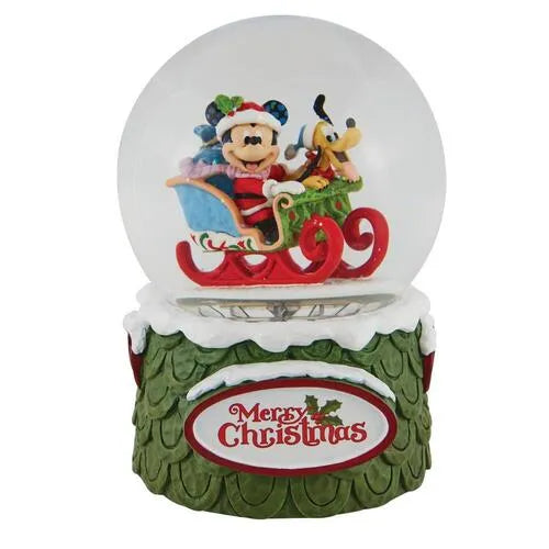 Front view of a Mickey Mouse and Pluto Christmas snow globe, sleigh scene inside, "Merry Christmas" plaque on green base
