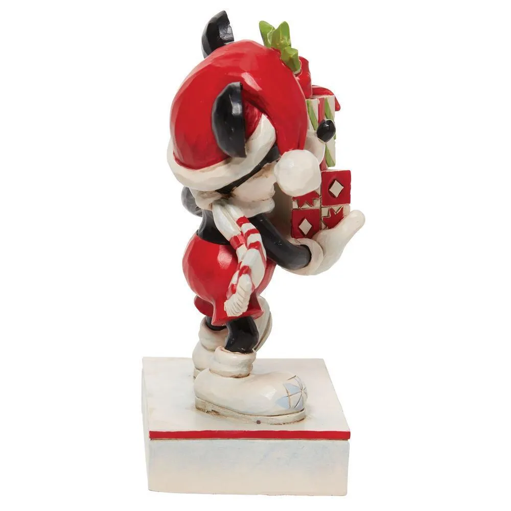 Left side view of Jim Shore Mickey figurine balancing wrapped gifts with candy cane striped scarf