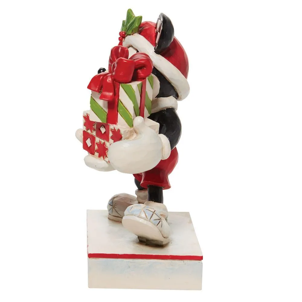Right side view of Mickey holding wrapped presents with candy cane pattern gift on holly base