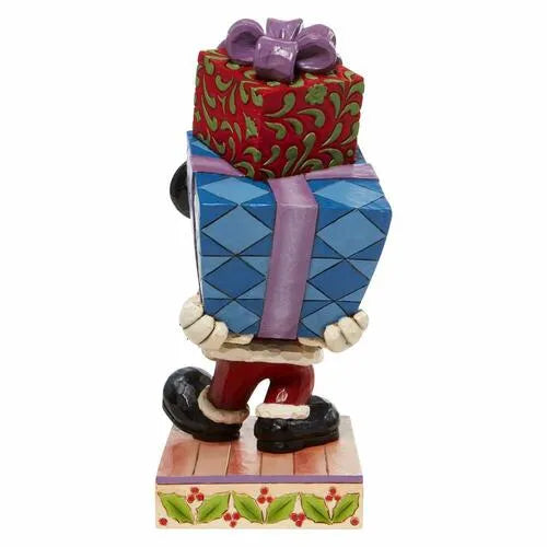 Rear view of Mickey Mouse Christmas figurine carrying a stack of decorated gift boxes, holly-trimmed base.
