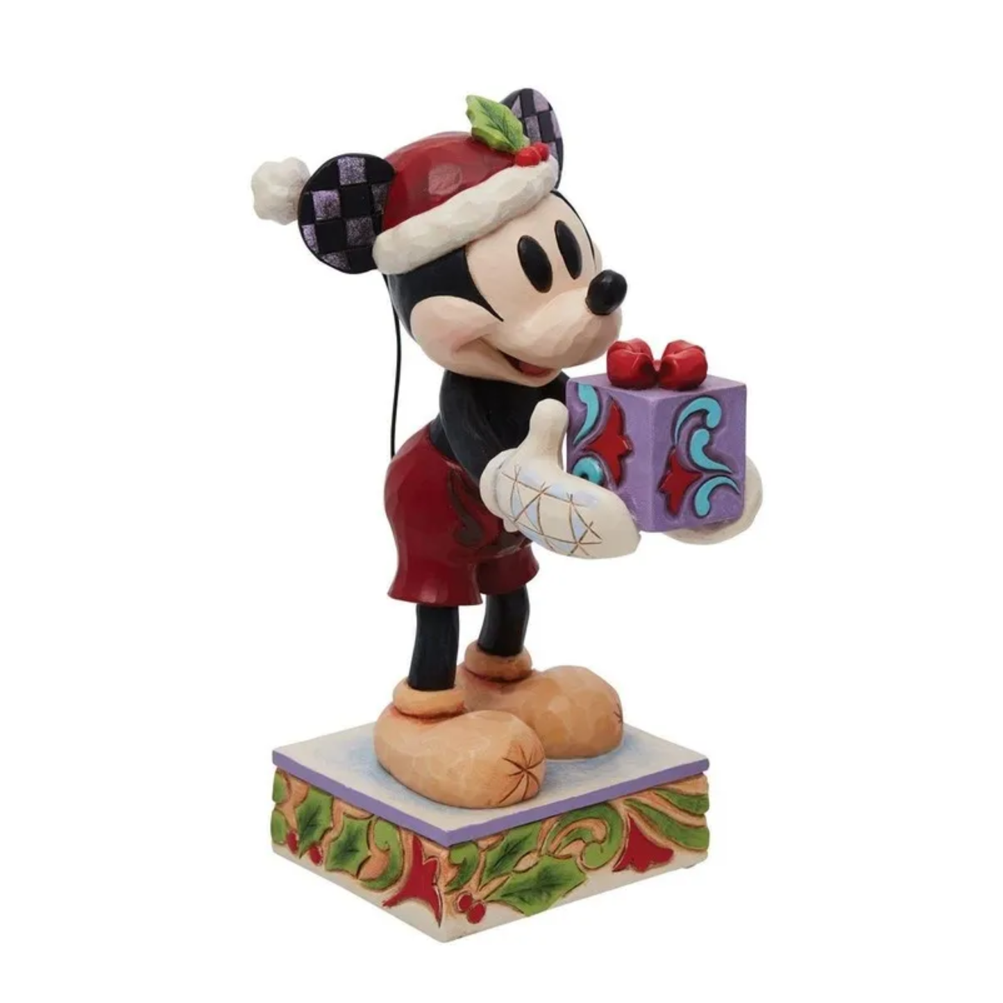 Mickey Mouse in Santa hat holding wrapped gift, standing on holly-decorated base with checkered ears
