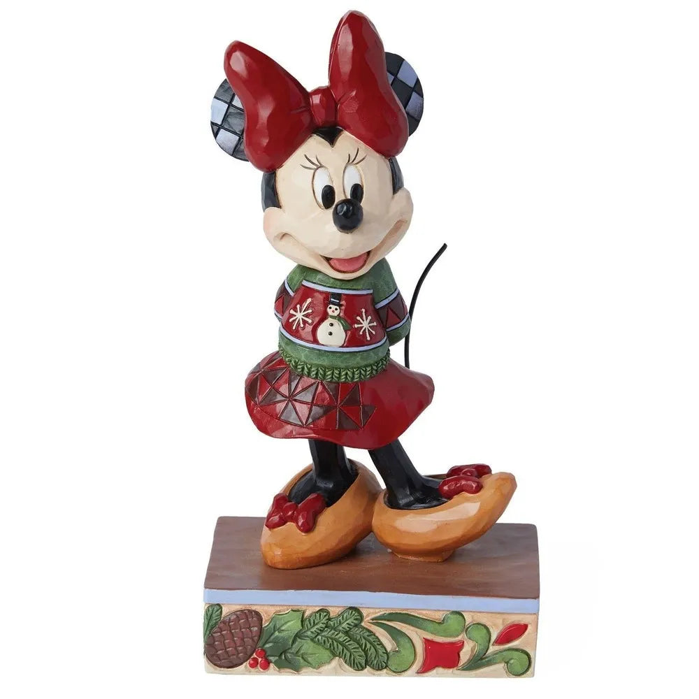 Angled front view of a Minnie Mouse Christmas figurine wearing a snowman sweater and red skirt, on a holly and pinecone base.