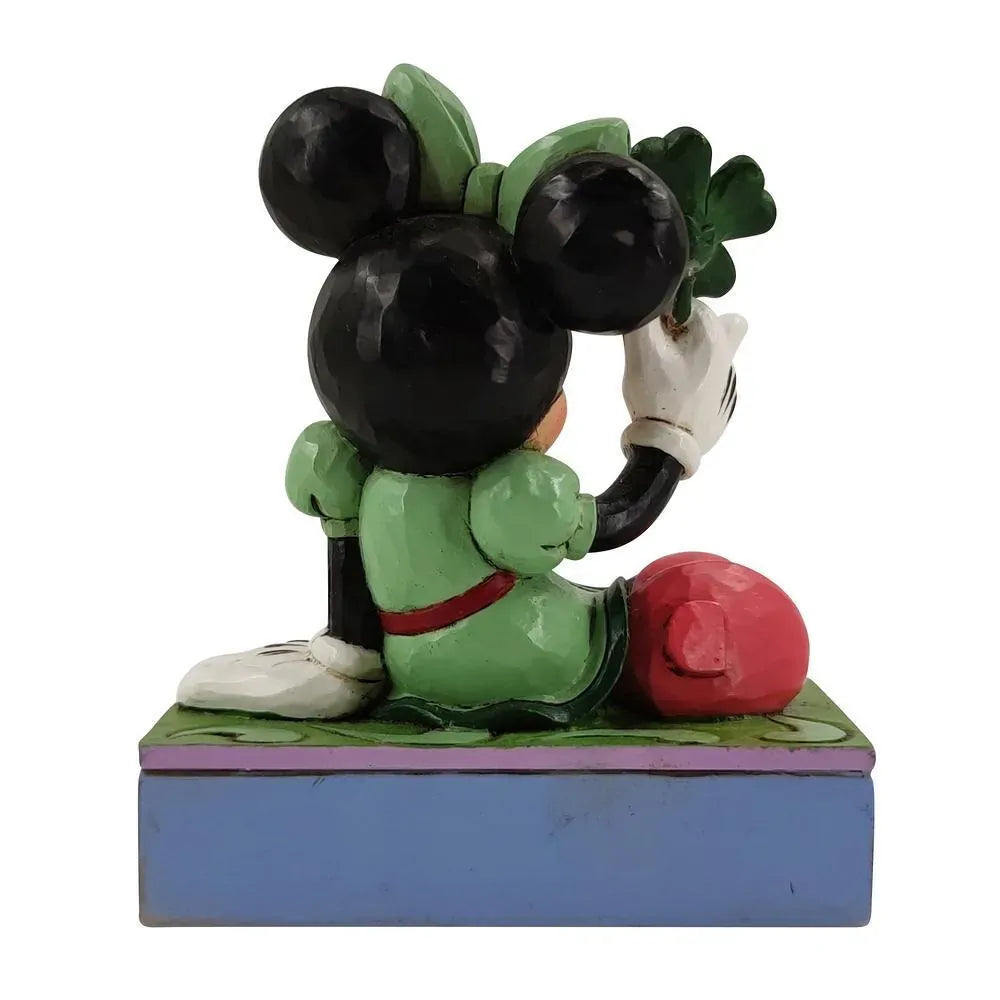 Rear view of Minnie Mouse St. Patrick's Day figurine in green outfit holding a shamrock, on rainbow and clover base 