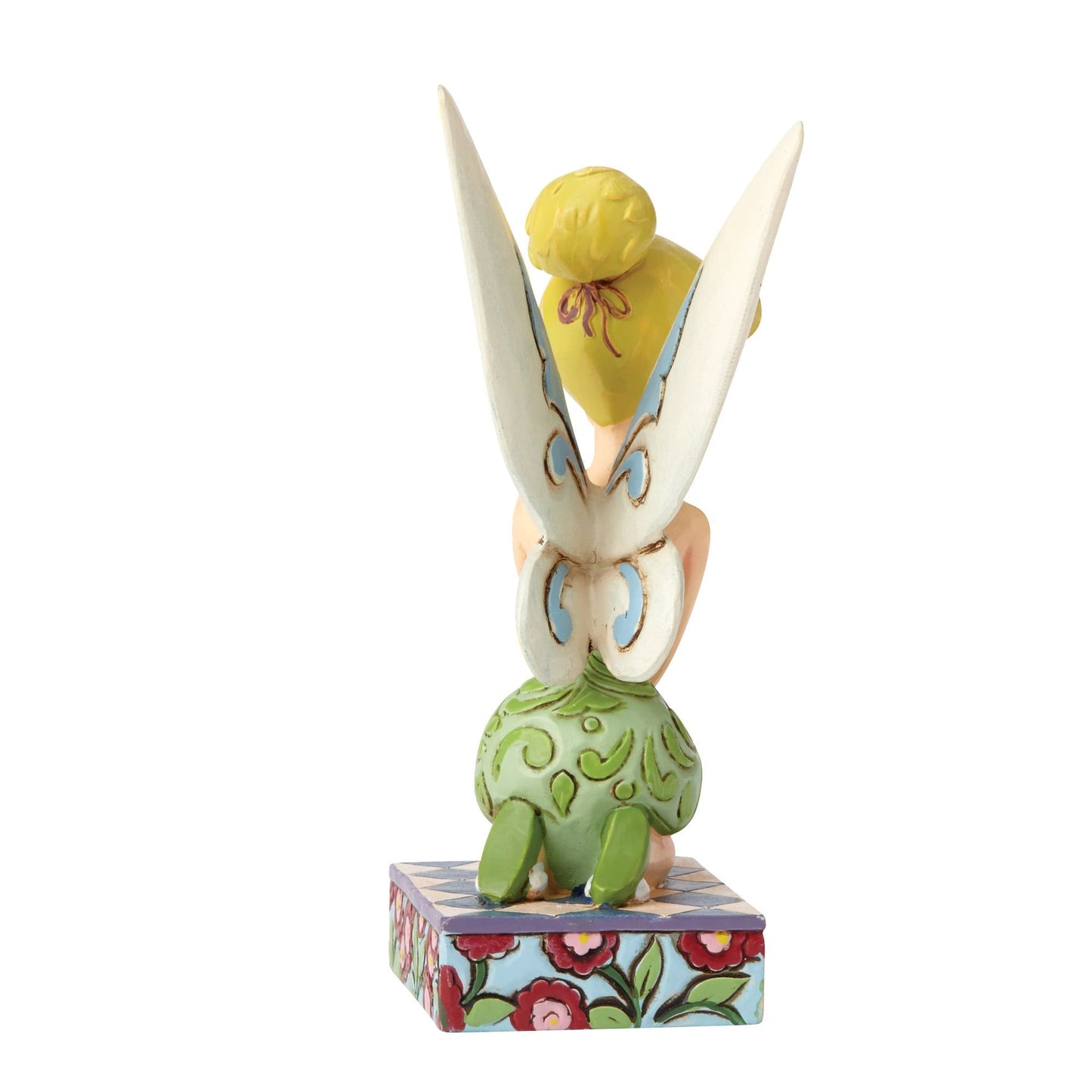 Tinker Bell figurine rear view highlighting large white and blue wings with scrollwork detail above a floral patterned base