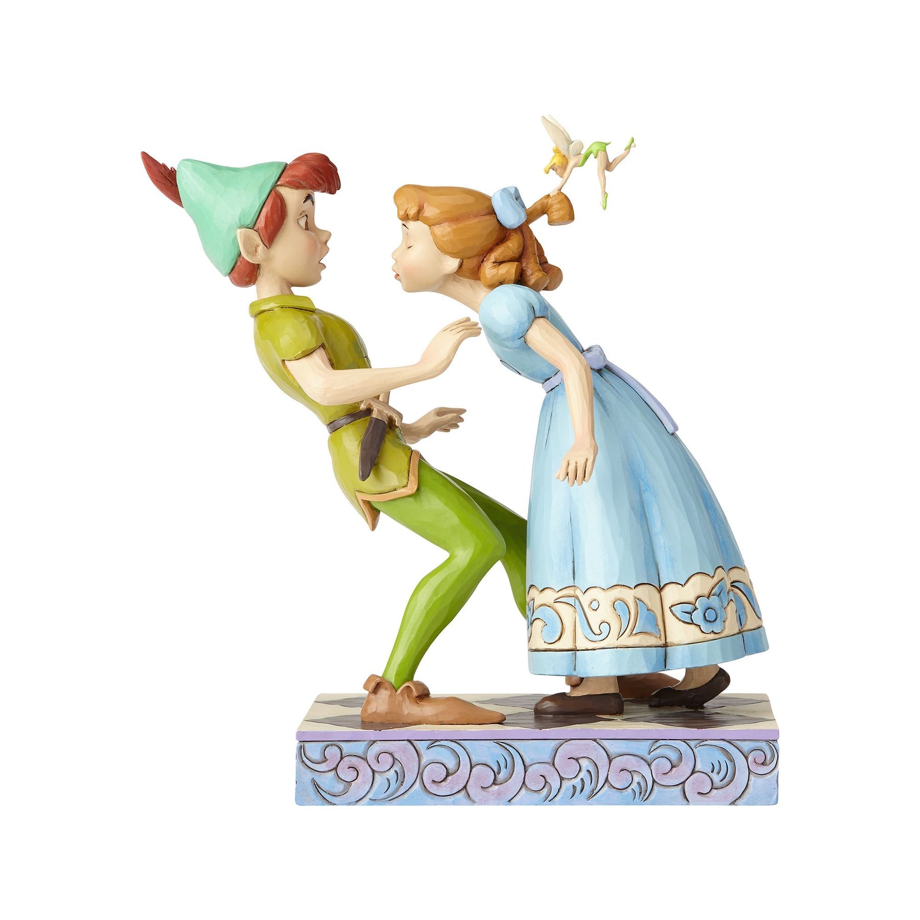 Peter Pan and Wendy figurine front view, Wendy leaning in to kiss a wide-eyed Peter, Tinker Bell hovering above, scrollwork base