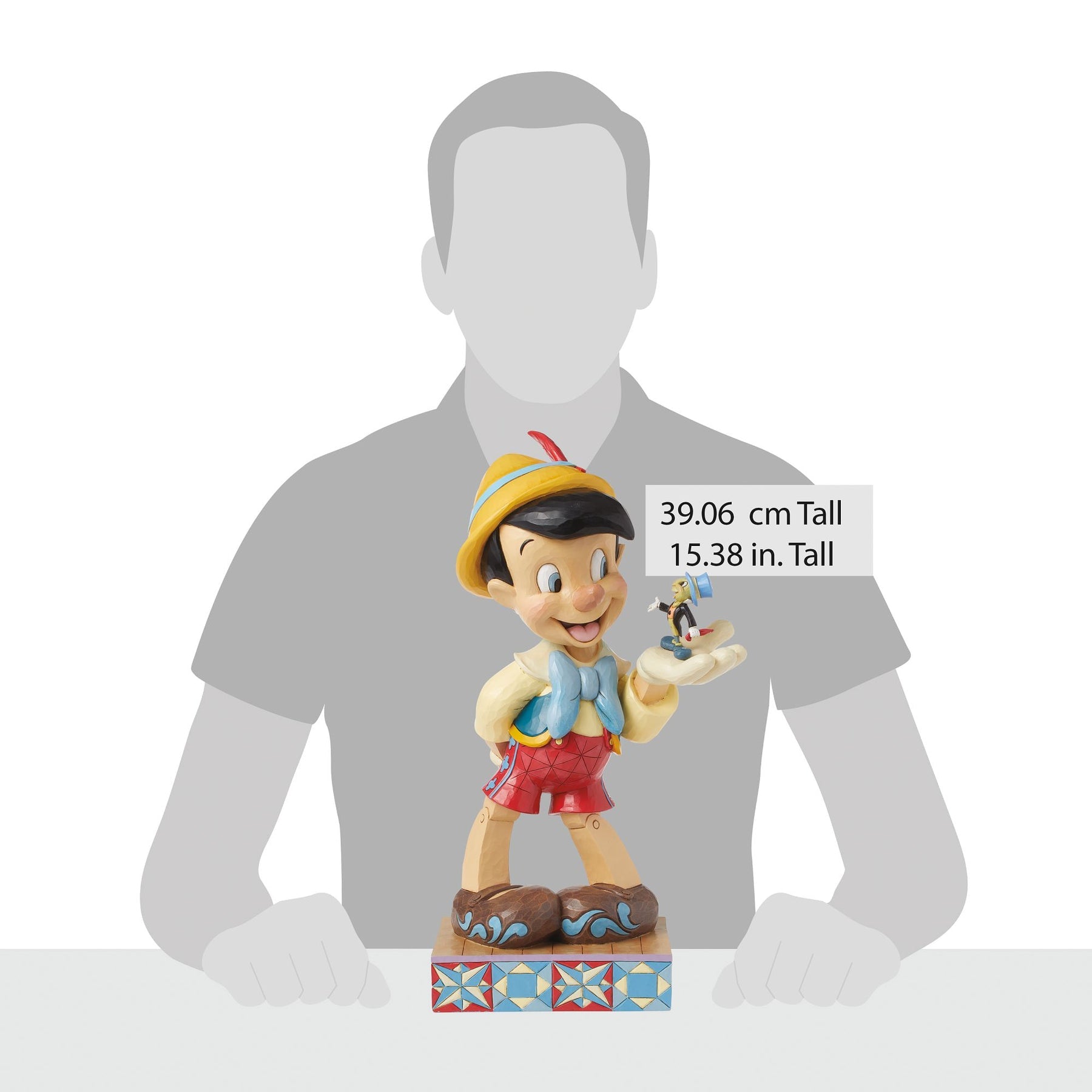 Pinocchio and Jiminy Cricket figurine shown against human silhouette for scale, 39.06 cm / 15.38 inches tall 