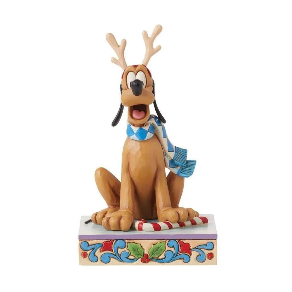 Front view of a Pluto Christmas figurine wearing reindeer antlers and a blue argyle scarf, seated on a candy cane with holly base