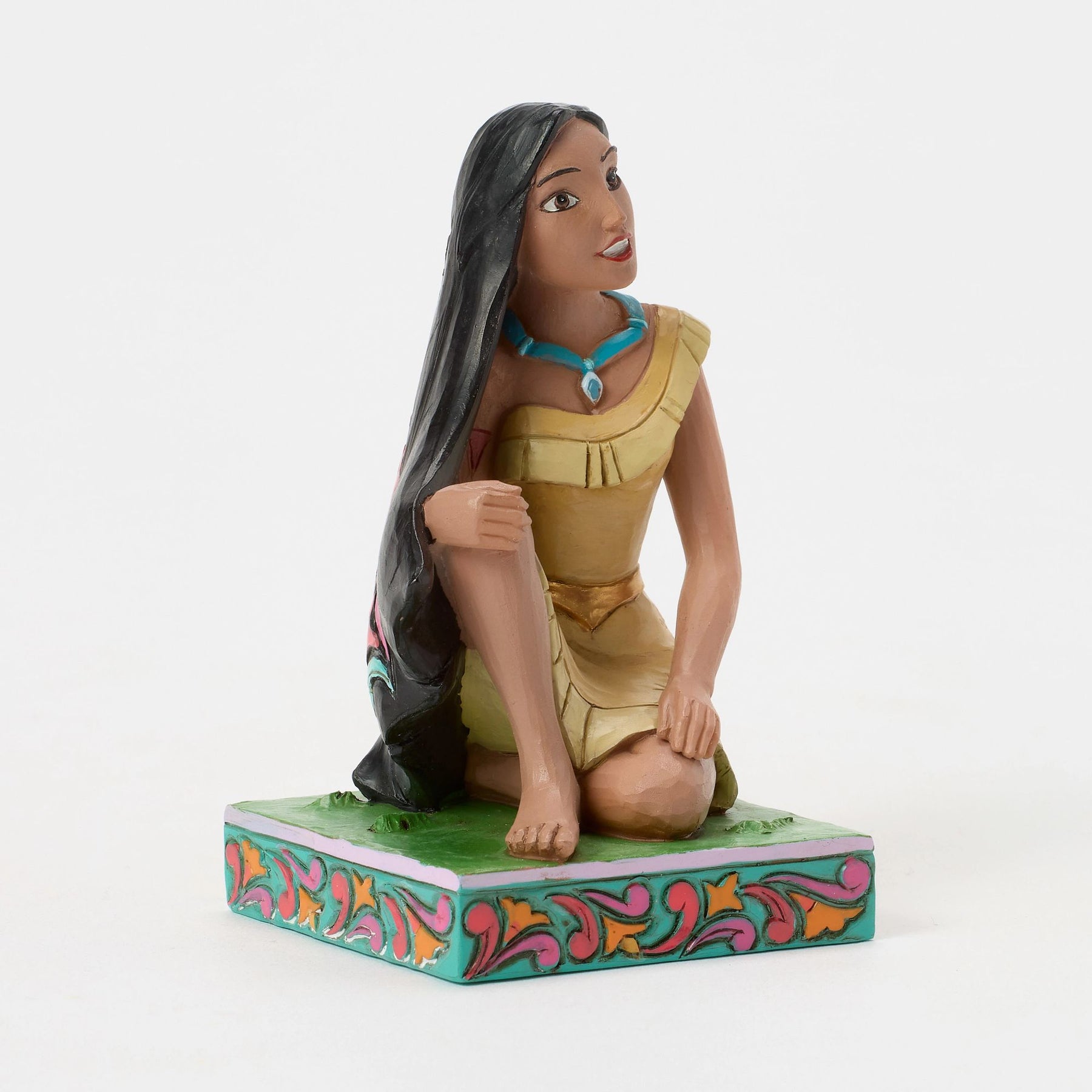 Pocahontas figurine seated in gold dress, long black hair, teal necklace, looking upward, vibrant painted base