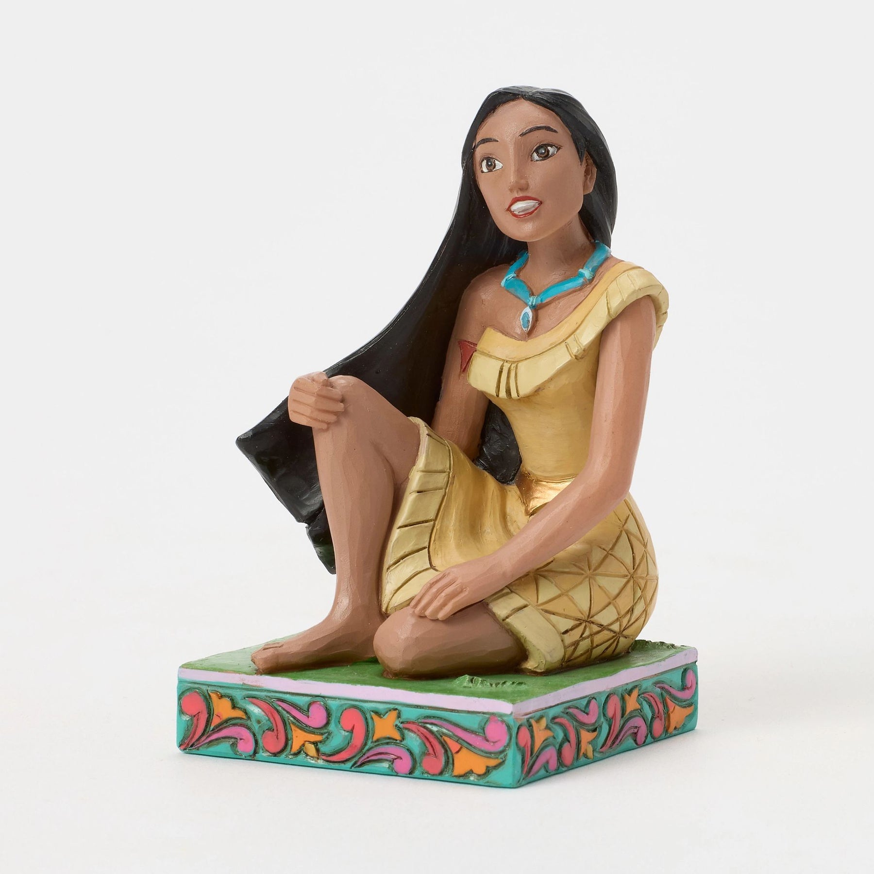 Front view of Pocahontas figurine seated in gold dress with teal necklace, long black hair, vibrant teal painted base 