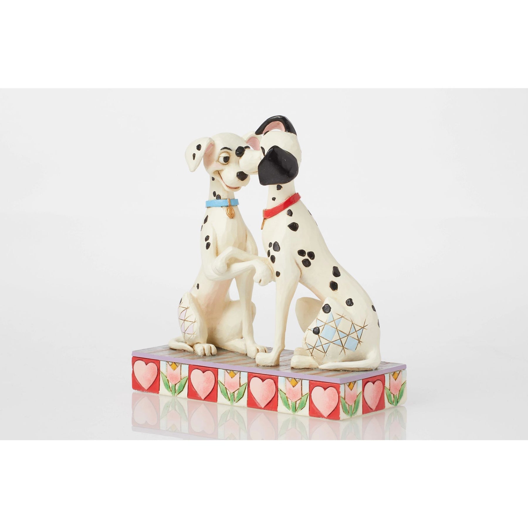 Front view of Pongo and Perdita figurine from 101 Dalmatians touching noses with paws clasped, heart and tulip base