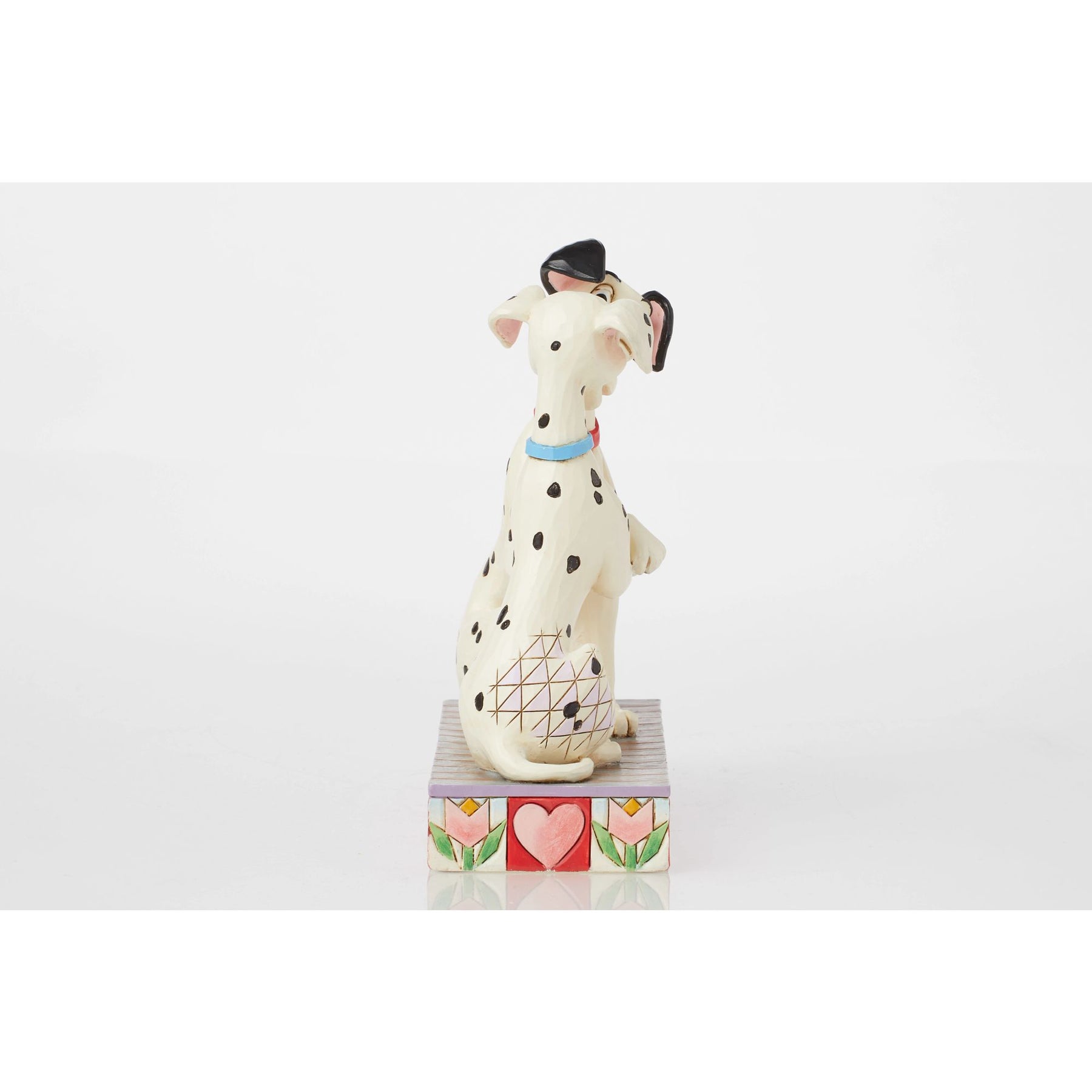 Side view of Pongo figurine from 101 Dalmatians, red collar, seated on heart and tulip painted base