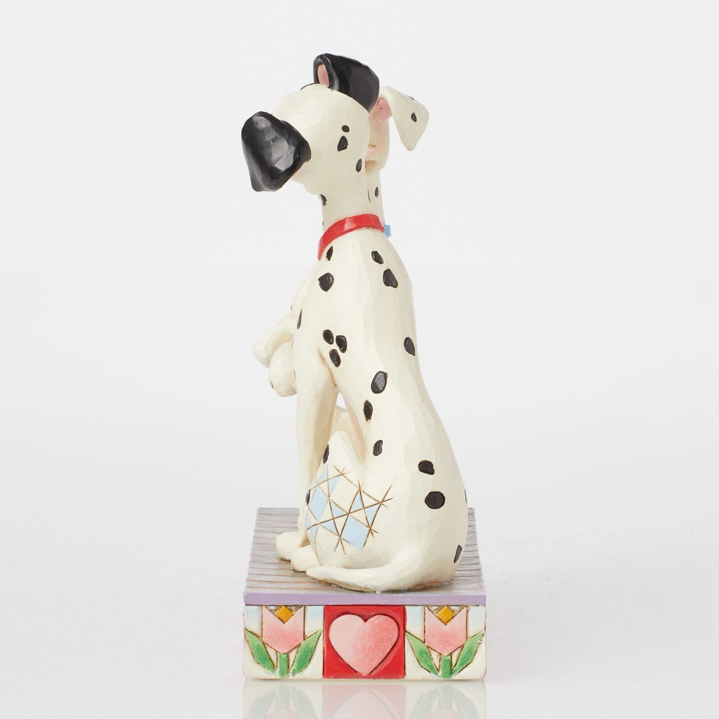 Side view of Perdita figurine from 101 Dalmatians, blue collar, seated on heart and tulip painted base