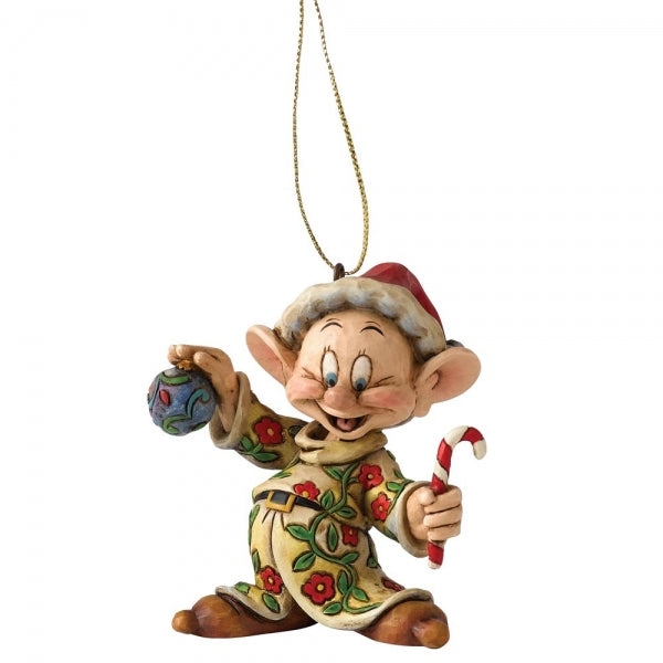Dopey dwarf hanging ornament with folk art detailing, holding a bauble and candy cane, in a floral coat and Santa hat