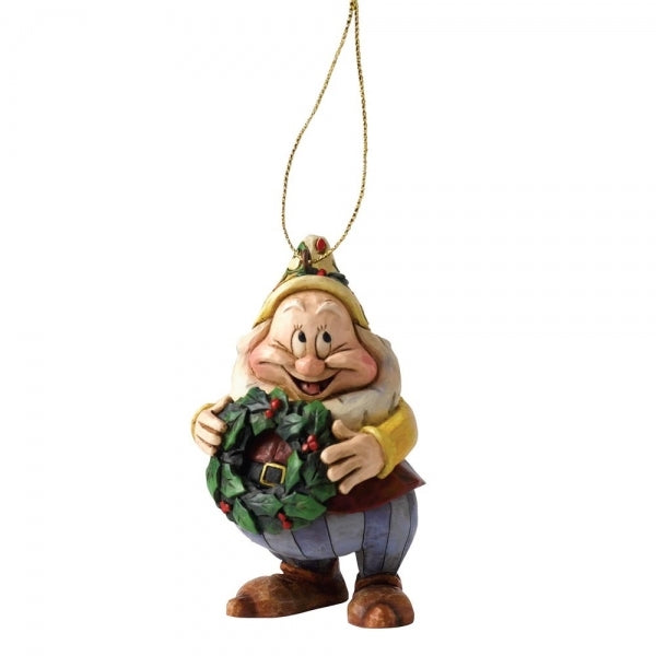 Happy dwarf hanging ornament with folk art detailing, smiling and holding a holly wreath, in a yellow hat and blue trousers 