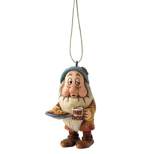 Sleepy dwarf hanging ornament with folk art detailing, holding a hot cocoa mug and plate of cookies in a patterned coat