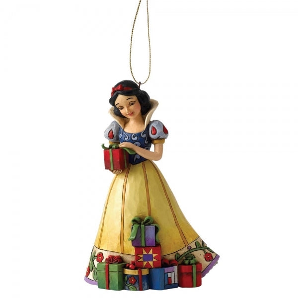 Snow White hanging ornament with folk art detailing, holding a gift in her yellow and blue dress, surrounded by wrapped presents