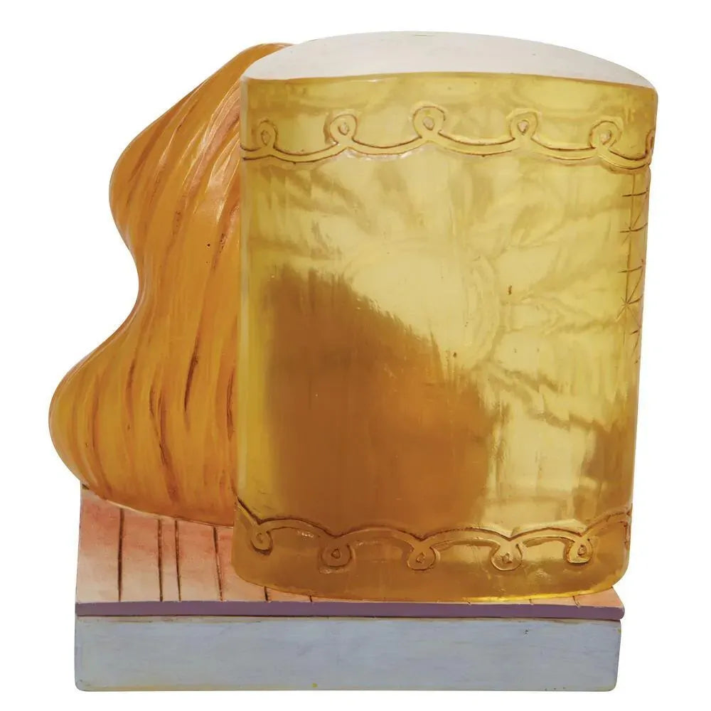 Rear view of Rapunzel figurine showing her long golden hair cascading beside an engraved tower column, on painted base