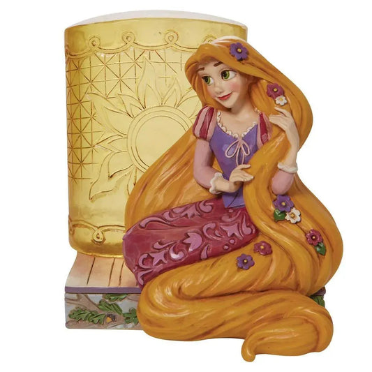 Rapunzel figurine front view, seated with flower-woven hair beside a sun-engraved golden tower on a floral painted base