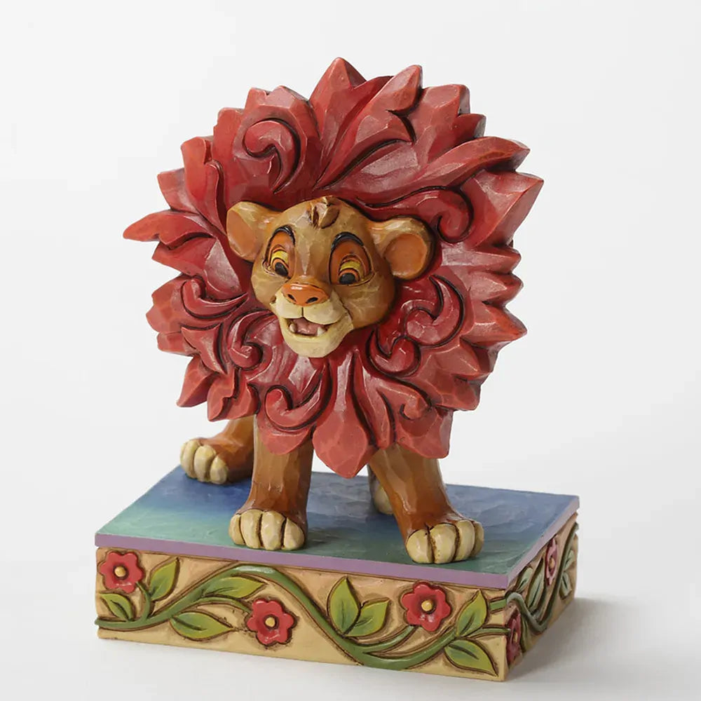 Young Simba Lion King figurine rear view showing red scrollwork mane detail and cub body on a painted floral vine base