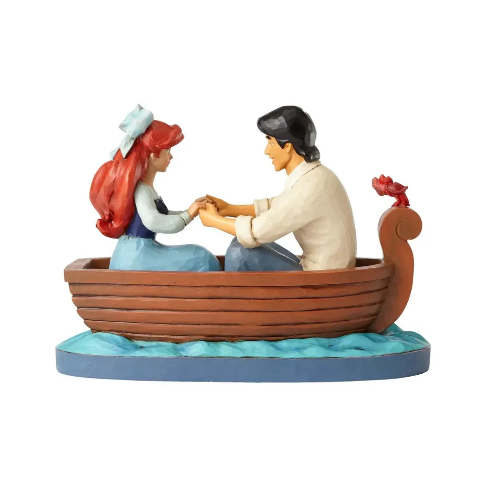 Ariel and Prince Eric rowboat figurine rear view, showing plain boat exterior on a painted wave base with Sebastian on stern