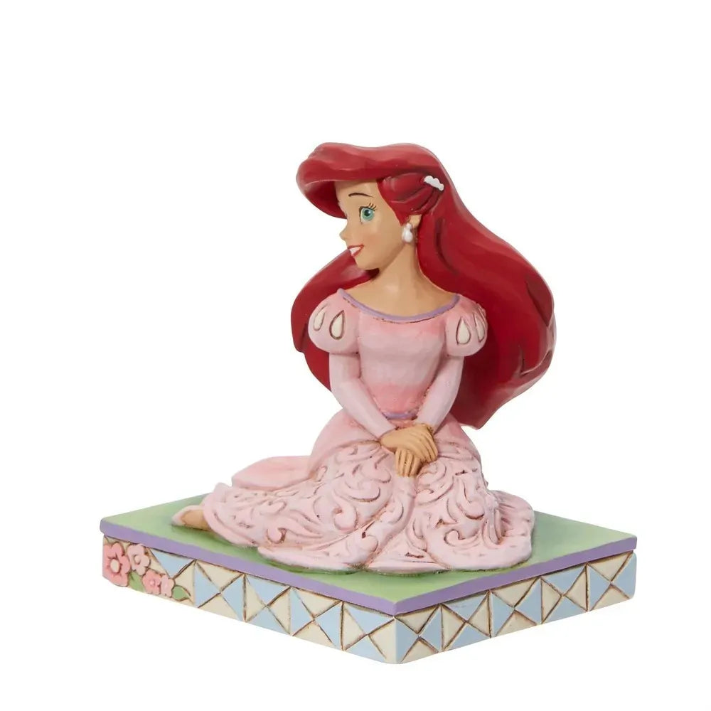 Ariel figurine seated in pink gown with scrollwork skirt, red hair, pearl earring, floral lattice base