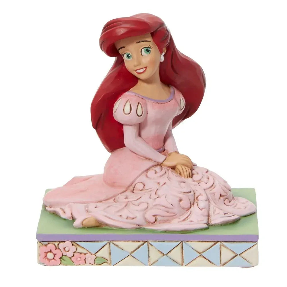 Front view of Ariel figurine in pink gown with scrollwork skirt, red hair, green eyes, floral lattice base