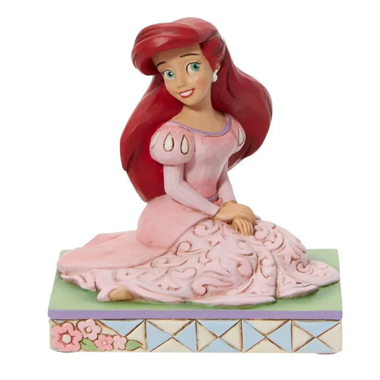 Front view of Ariel figurine in pink gown with scrollwork skirt, red hair, green eyes, floral lattice base