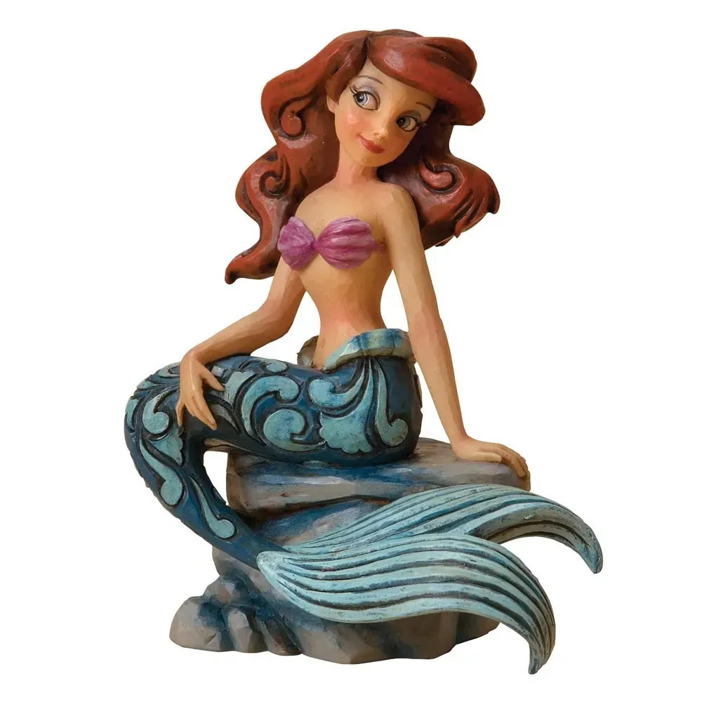 Ariel figurine seated on a painted rock base, purple shell top, blue scrollwork mermaid tail with fin detail, red wavy hair