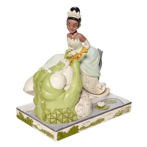 Tiana and Louis figurine, front view, Louis playing trumpet while Tiana in white gown leans beside him on decorative base