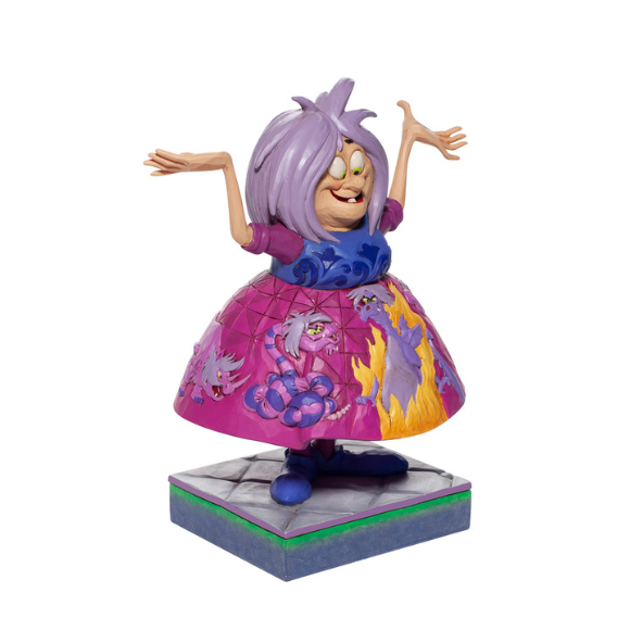 Madam Mim figurine facing forward, arms outstretched, wearing a full pink skirt painted with cats and flames, on grey base